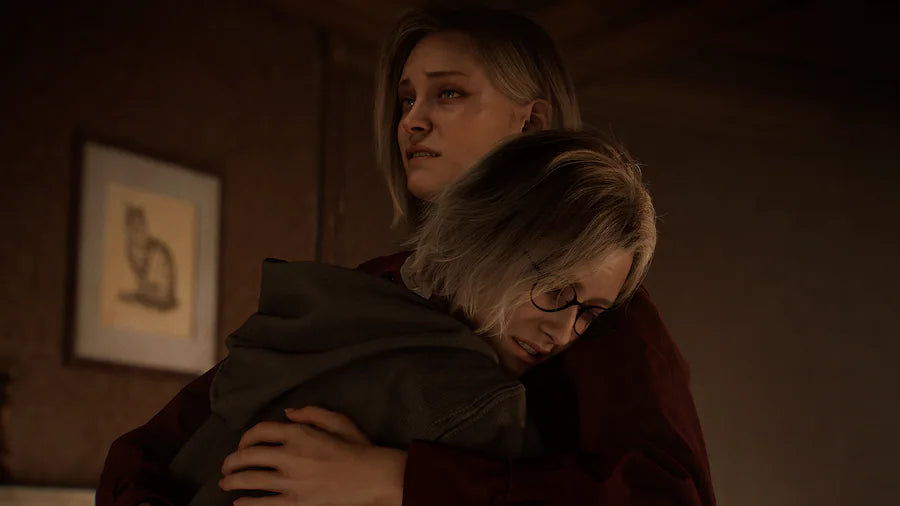 Two women embracing in a dimly lit room with a painting on the wall.
