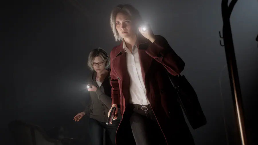 Two people in dark clothing with flashlights in a dimly lit setting